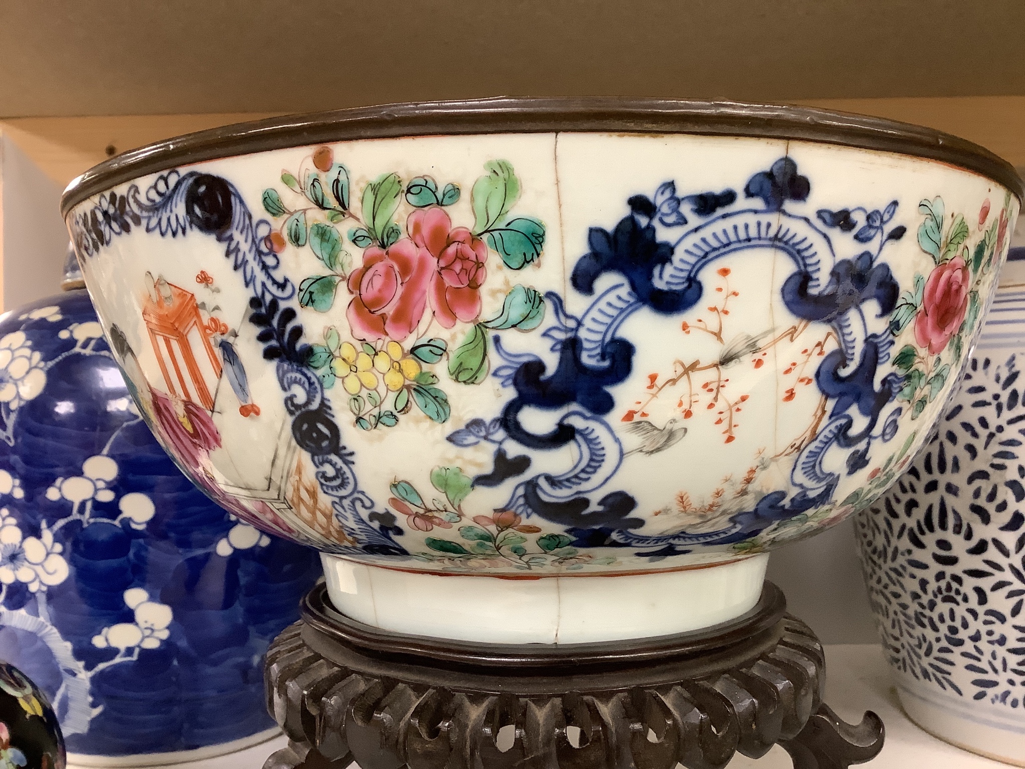 A 19th century Chinese porcelain prunus jar and cover, 27cm, on carved wood stand, a smaller famille noire jar and cover, a Chinese export fruit bowl, blue and white dish and a similar jar and cover 27cm
